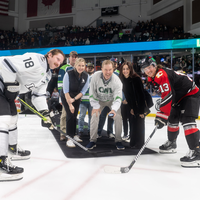 Gordon Jones, President of College of Western Idaho, prepares to drop the puck at a hockey game.