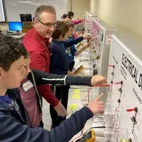 Robert Novak, Department Chair of Engineering, talks with students during STEM Out!
