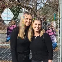 CWI students working with children butterfly costumes posing