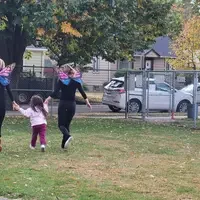 CWI students working with children in butterflies customs with child running