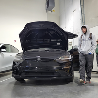 Student walking past a Tesla