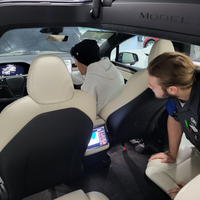 Students observing Tesla vehicles controls