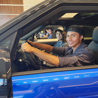 People sitting in cars looking at the camera
