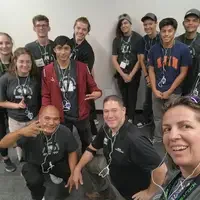 Group of people posing for a photo and looking at the camera