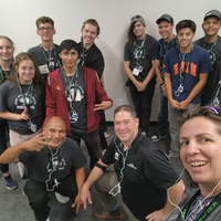 Group of people posing for a photo and looking at the camera