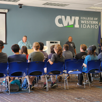 Group of people in a classroom listening to speakers