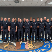 Groups of graduate pose for a picture