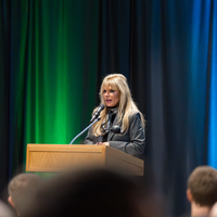 Provost Denise Aberle-Cannata speaks behind podium