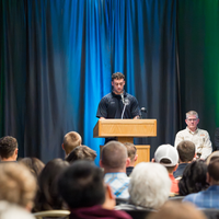 Christian Tiner speaking behind podium