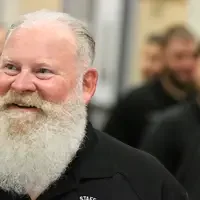 LeRoy Forsman, Sr. Program Coordinator with the Law Enforcement program, speaks with guests before graduation on May 16.