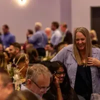 People chatting and laughing at Opening Doors event