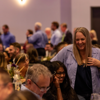 People chatting and laughing at Opening Doors event