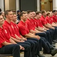 Row of smiling graduates.
