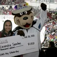 Casandra Sanchez, SCORE Big Scholarship recipient, with Idaho Steelheads mascot, Blue.