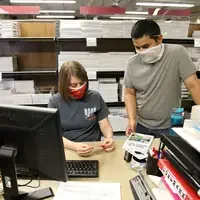 Sara Wagner, left, talks with Freddy Anzaldua while they complete an order on Sept. 3