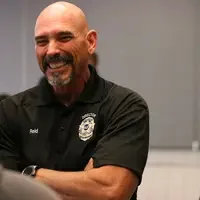 Brett Reid, Director of Law Enforcement at CWI, shares a laugh with guests during the event.