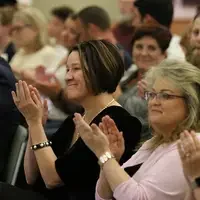 Nursing Department Chair, Allison Baker, applauds graduates during Pinning Ceremony