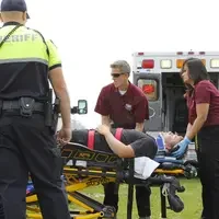 Advanced EMT students evaluating condition of patient.