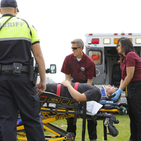 Advanced EMT students evaluating condition of patient.