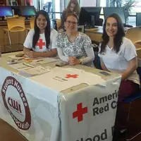 Members of SNA sitting at a table at the Nampa Campus Academic Building for a blood drive