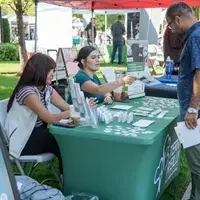Students grabbing flyers and material at booth
