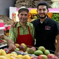Edgar Rosales, 17, right,  pauses for a photo with his father, Emilio Rosales, at their family business in Caldwell, Idaho on May 31, 2017. “I don’t want him to have to work in the store anymore, it’s very hard. He’s Hispanic and I want him to be able to accomplish more — this is so important, sometimes it makes me cry,” said Emilio. (Ashley Smith/College of Western Idaho)