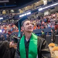 Graduate looks at stands 