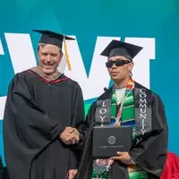 Student accepting diploma