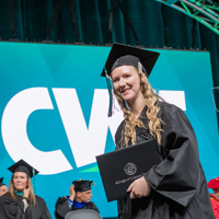 Graduates walk the stage with degree