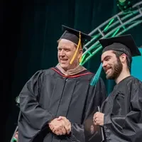 Student and Jones shaking hands