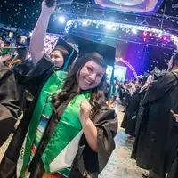 Students cheering after graduation