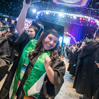 Students cheering after graduation