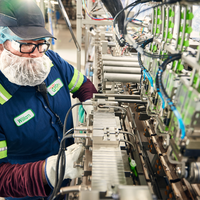 Student working on assembly line equipment