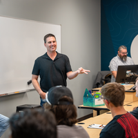 Jim Reames speaking to students in front of classroom