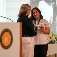 Instructor hands student an award