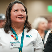 Student sits and smiles