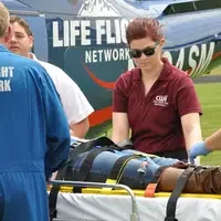 Advanced EMT students helping transport patient to Life Flight helicopter.