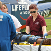 Advanced EMT students helping transport patient to Life Flight helicopter.