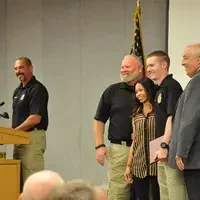 Graduates receive certificates at the completion ceremony.