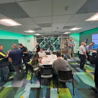 A group of people interacting in a meeting room