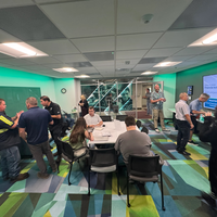 A group of people interacting in a meeting room