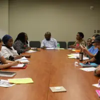 Students in the EVS Pre-apprenticeship class sitting around a table together