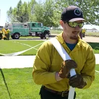 Firefighters running drills with firehose