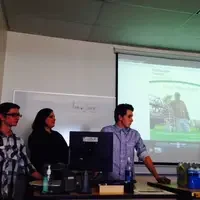 Marketing students giving presentation in front of classroom.