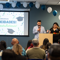 Audience members look on during a graduation ceremony.