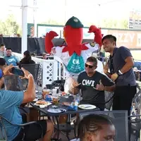 CWI Foundation member, Ben Chaney, poses with Humphrey the Hawk who is sporting a CWI backpack