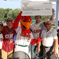 Hawks mascot presents check to members of CWI leadership
