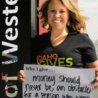 Nikki Houston Headshot with Why I Give sign