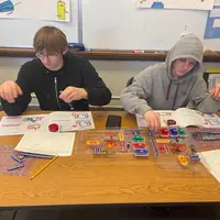 Two students learning with CTE Dual Credit resources