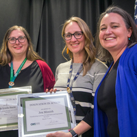 Winners hold their certificates at a faculty professional development event.